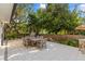 Outdoor patio featuring an outdoor dining set, with a backyard surrounded by trees at 208 Live Oak Ln, Largo, FL 33770