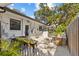 Backyard with white stone landscaping, wrought iron gate and fence, and various plants at 208 Live Oak Ln, Largo, FL 33770