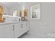Modern bathroom with white cabinets, quartz countertop, and stylish fixtures at 208 Live Oak Ln, Largo, FL 33770