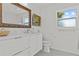 Bathroom features classic vanity with a white countertop, and a framed mirror at 208 Live Oak Ln, Largo, FL 33770