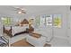 Sunlit bedroom with white walls, bed and lounger, view to outside at 208 Live Oak Ln, Largo, FL 33770