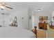 Bright bedroom with white walls, view to ensuite bath, dresser and lounger at 208 Live Oak Ln, Largo, FL 33770
