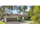 Beautiful one-story home with an attached garage, landscaped front yard, and inviting curb appeal at 208 Live Oak Ln, Largo, FL 33770
