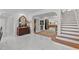 Welcoming foyer with glossy marble floors, staircase, and elegant décor, creating a grand entrance at 208 Live Oak Ln, Largo, FL 33770