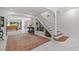 Bright foyer featuring tile floors, a staircase, and an inviting view into the living spaces at 208 Live Oak Ln, Largo, FL 33770