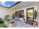 Charming covered front porch with tiled flooring and a seating area at 208 Live Oak Ln, Largo, FL 33770