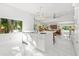Open-concept kitchen with white cabinets, a center island, and seamless flow to the living areas at 208 Live Oak Ln, Largo, FL 33770