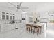 Spacious white kitchen featuring a large island, stainless steel appliances, and barstool seating for casual dining at 208 Live Oak Ln, Largo, FL 33770