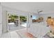 Sun-filled main bedroom with outdoor access to the patio and pool area at 208 Live Oak Ln, Largo, FL 33770