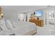 Well-lit main bedroom with a TV, dresser, and access to a walk-in closet and bathroom at 208 Live Oak Ln, Largo, FL 33770