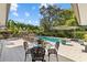 Inviting outdoor pool area surrounded by lush landscaping and ample seating at 208 Live Oak Ln, Largo, FL 33770