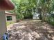 Large backyard featuring mature trees, a storage shed, and a mix of sun and shade at 21352 Lehouier Dr, Brooksville, FL 34601