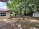 Backyard featuring mature trees and a storage shed at 21352 Lehouier Dr, Brooksville, FL 34601