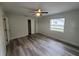 Comfortable bedroom features fresh gray flooring, a ceiling fan, and closet space at 21352 Lehouier Dr, Brooksville, FL 34601