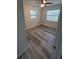 This bedroom features light walls, a ceiling fan, wood-look floors and two windows at 21352 Lehouier Dr, Brooksville, FL 34601
