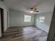 Inviting bedroom with ample natural light and fresh gray tone walls and flooring at 21352 Lehouier Dr, Brooksville, FL 34601
