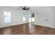 Bright bedroom with wood-look floors, slider doors leading to the yard, and neutral walls at 2328 W La Salle St, Tampa, FL 33607