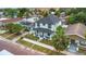 Stunning aerial view of two-story home with black fence, lush landscaping, and welcoming front porch at 2328 W La Salle St, Tampa, FL 33607