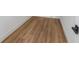 Close up on brown laminate flooring with white baseboards and dark hardware at 2328 W La Salle St, Tampa, FL 33607