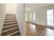 Bright foyer with wood staircase and flooring, fresh white paint and front door entrance with glass panels at 2328 W La Salle St, Tampa, FL 33607