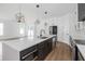 Modern kitchen boasts a large island with white countertops, stainless steel appliances, and stylish pendant lighting at 2328 W La Salle St, Tampa, FL 33607