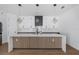 A spacious kitchen featuring white cabinets, stainless steel appliances, and cube pendant lighting at 2328 W La Salle St, Tampa, FL 33607