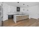 Beautiful kitchen featuring white cabinets, marble backsplash, stainless steel appliances, and waterfall island at 2328 W La Salle St, Tampa, FL 33607