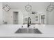 Bright, open kitchen with a large island, stainless steel sink, and modern pendant lighting, perfect for entertaining at 2328 W La Salle St, Tampa, FL 33607
