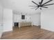 A neutral open-concept living room featuring dark floors and an adjacent kitchen area with an island at 2328 W La Salle St, Tampa, FL 33607