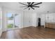 Open living room featuring wood floors, a sliding glass door, and a view of the kitchen and breakfast bar at 2328 W La Salle St, Tampa, FL 33607