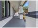 Covered porch with gray painted floor and contrasting black and white column and trim design at 2328 W La Salle St, Tampa, FL 33607