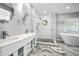 This contemporary bathroom offers a double vanity, standalone shower, and an adjacent soaking tub at 2459 Parkstream Ave, Clearwater, FL 33759