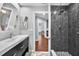 This modern bathroom features a stand-up shower with dark tile and a single vanity sink at 2459 Parkstream Ave, Clearwater, FL 33759