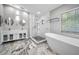 This contemporary bathroom features a soaking tub, standalone shower, and double vanity at 2459 Parkstream Ave, Clearwater, FL 33759