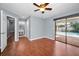This bedroom includes hardwood floors, a ceiling fan, and sliding doors to the pool area at 2459 Parkstream Ave, Clearwater, FL 33759