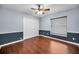 This bedroom features hardwood floors, a large closet, and a window with custom shades at 2459 Parkstream Ave, Clearwater, FL 33759