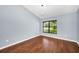Bedroom featuring wood floors and a nice window at 2459 Parkstream Ave, Clearwater, FL 33759