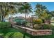 Community entrance with a brick sign surrounded by lush landscaping at 2459 Parkstream Ave, Clearwater, FL 33759