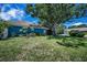 Charming blue single-story home featuring a red tile roof and lush green lawn at 2459 Parkstream Ave, Clearwater, FL 33759