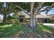 Charming home with lush landscaping, mature trees, and a well-maintained lawn at 2459 Parkstream Ave, Clearwater, FL 33759