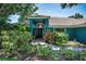 Inviting home with colorful landscaping, arched entry, and tile roof at 2459 Parkstream Ave, Clearwater, FL 33759
