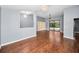 Bright living room featuring hardwood floors and sliding glass doors leading to the pool area at 2459 Parkstream Ave, Clearwater, FL 33759