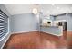 Open floor plan with hardwood floors, chandelier lighting, and a view of the kitchen at 2459 Parkstream Ave, Clearwater, FL 33759
