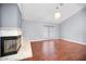 Living room with hardwood flooring, vaulted ceilings, fireplace, and chandelier lighting at 2459 Parkstream Ave, Clearwater, FL 33759