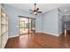 Spacious living room with hardwood floors and sliding glass doors overlooking the pool area at 2459 Parkstream Ave, Clearwater, FL 33759