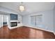 A bright living room featuring hardwood floors, a fireplace, and a large window offering ample natural light at 2459 Parkstream Ave, Clearwater, FL 33759