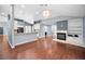 Spacious living room with hardwood floors offering a view to the kitchen and fireplace at 2459 Parkstream Ave, Clearwater, FL 33759