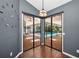 View through sliding glass doors to a screened patio, pavers, and pool at 2459 Parkstream Ave, Clearwater, FL 33759