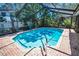 The inviting screened-in pool boasts clear water and a relaxing atmosphere with a brick-paved deck at 2459 Parkstream Ave, Clearwater, FL 33759