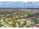 Beautiful aerial view of a golf course community with mature landscaping and lakes at 2518 Dick Wilson Dr, Sarasota, FL 34240